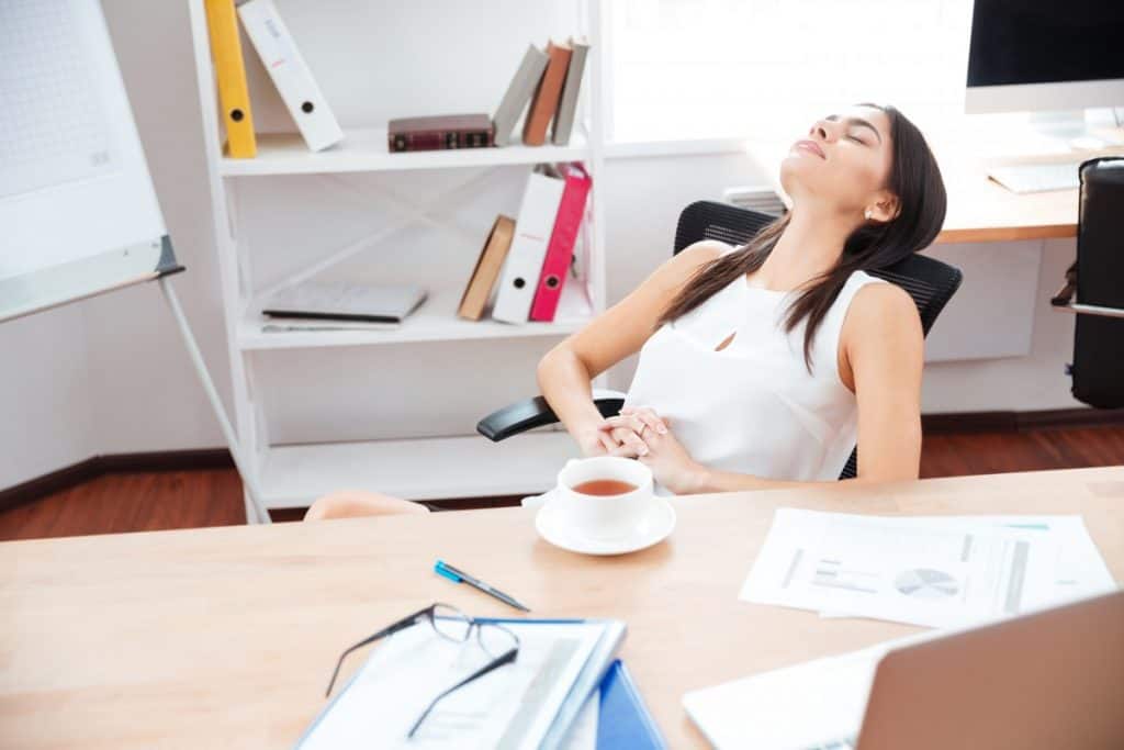 businesswoman relaxing in office P98QLQT